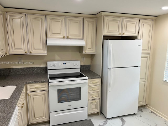 kitchen featuring sink, cream cabinetry, and white appliances