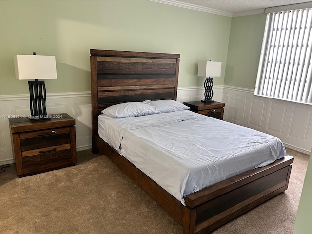 bedroom with carpet, crown molding, and a textured ceiling