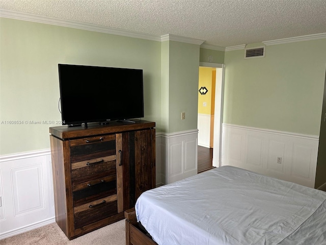 carpeted bedroom featuring a textured ceiling and crown molding