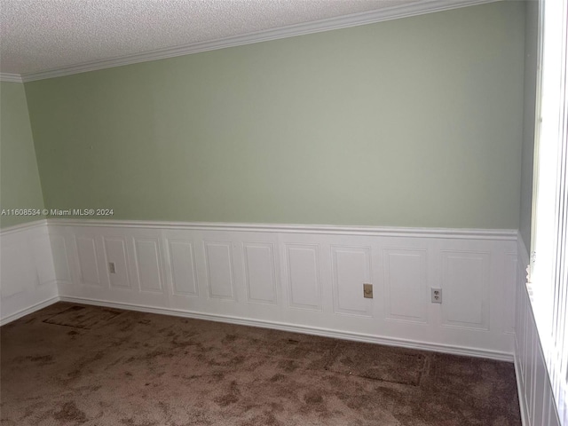 carpeted spare room featuring a textured ceiling and ornamental molding