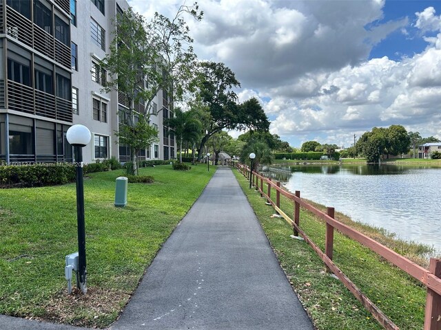 view of home's community featuring a water view and a yard