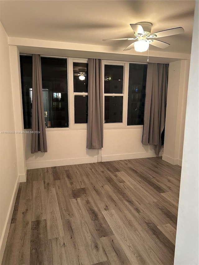 empty room featuring ceiling fan and wood-type flooring