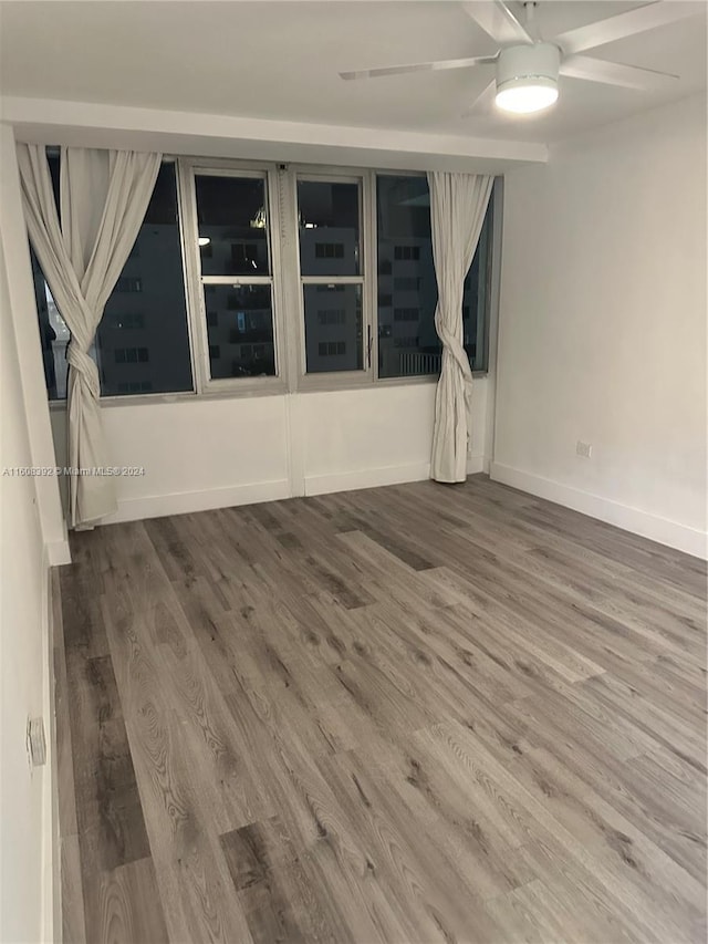 empty room featuring wood-type flooring and ceiling fan