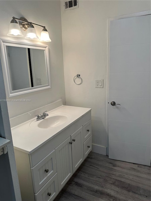 bathroom with vanity and hardwood / wood-style floors