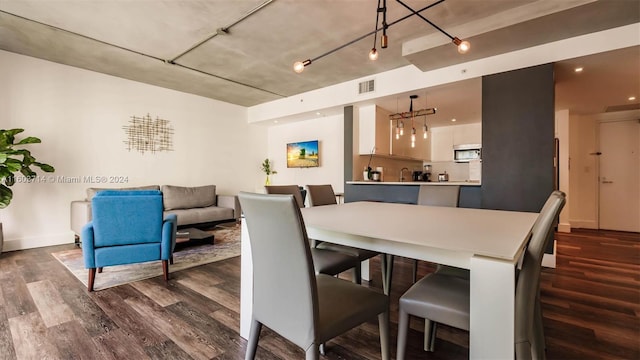 dining space with dark hardwood / wood-style flooring