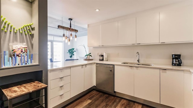 kitchen featuring dishwasher, white cabinetry, hanging light fixtures, and sink