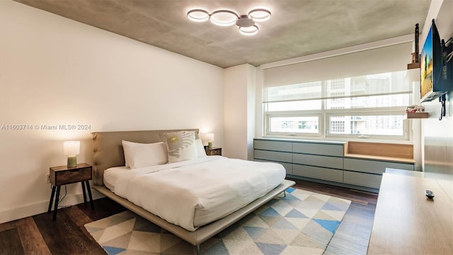 bedroom with dark wood-type flooring