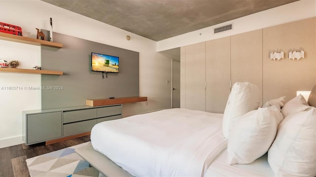 bedroom with dark wood-type flooring