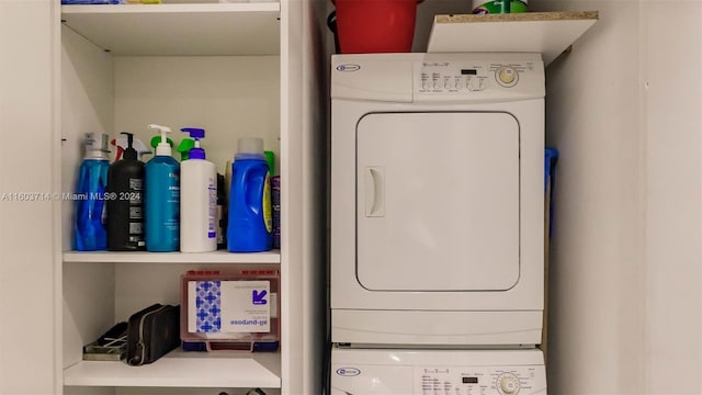 laundry room featuring stacked washer / drying machine