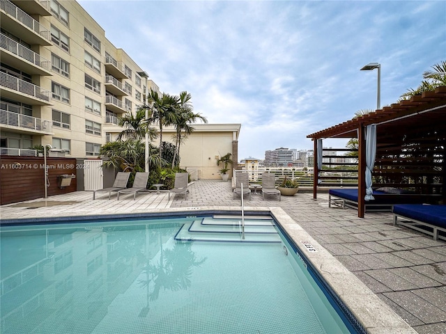 view of pool featuring a pergola and a patio area