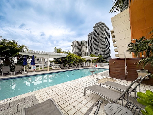 view of swimming pool featuring a pergola and a patio area