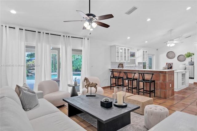 living room with ceiling fan and light tile floors