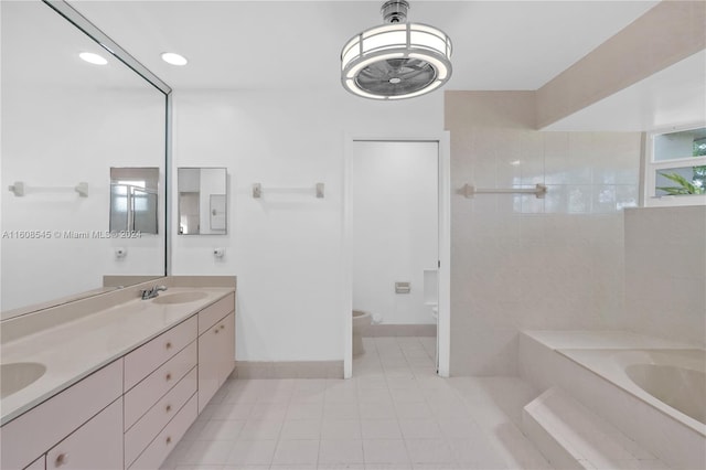 bathroom with double sink vanity, tile flooring, a bathing tub, and toilet