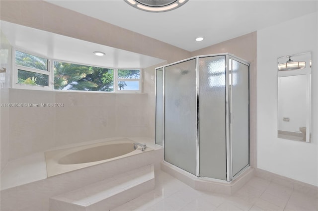 bathroom featuring tile floors and separate shower and tub