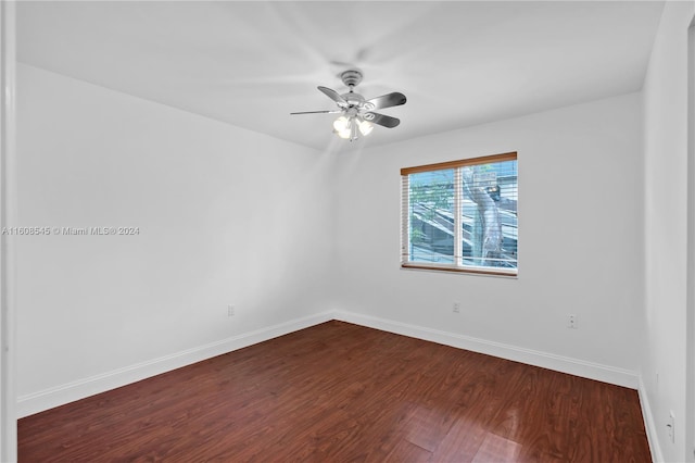 empty room with dark hardwood / wood-style floors and ceiling fan