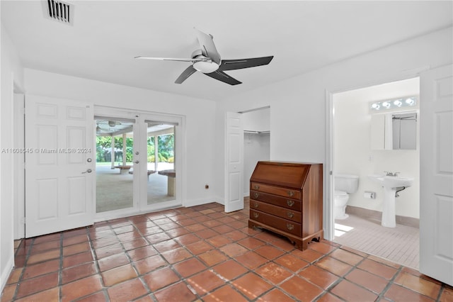 unfurnished bedroom with tile flooring, access to outside, a closet, ensuite bathroom, and ceiling fan