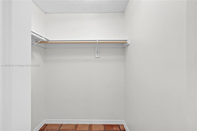 walk in closet featuring tile flooring