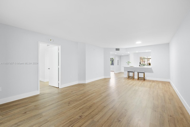 unfurnished living room with light hardwood / wood-style flooring