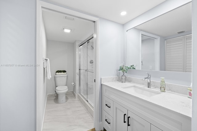 bathroom with walk in shower, vanity, and toilet