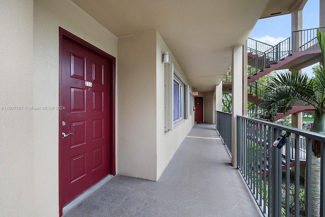 view of exterior entry featuring a balcony