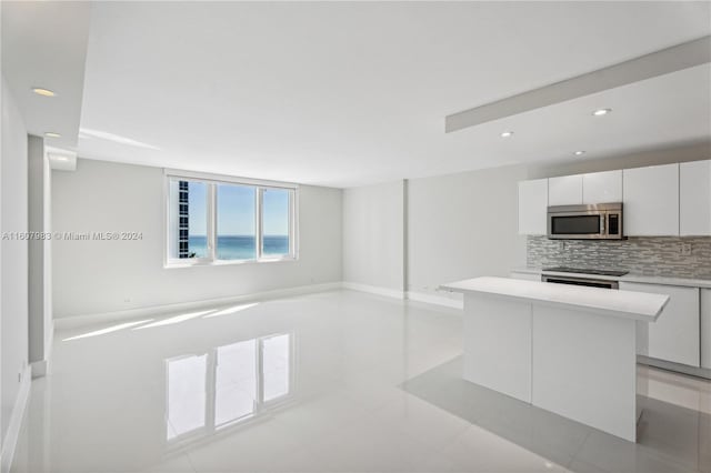 kitchen with stainless steel appliances, sink, backsplash, and white cabinets