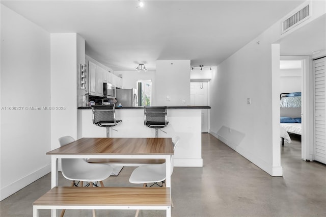 dining room featuring concrete flooring