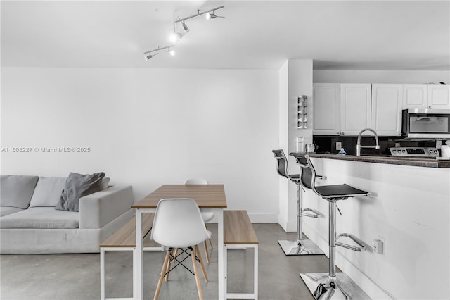 kitchen with decorative backsplash and white cabinetry