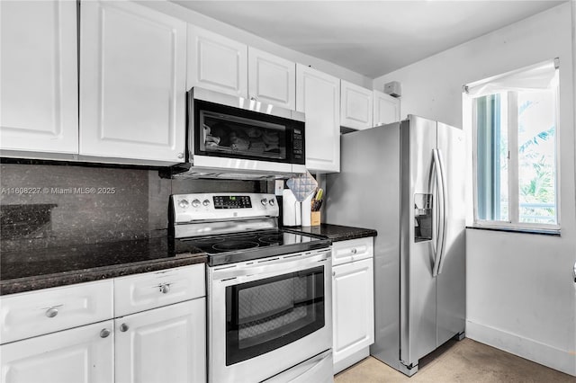 kitchen with dark stone counters, decorative backsplash, white cabinetry, and stainless steel appliances