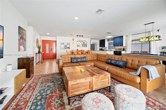 living room featuring light tile patterned floors and billiards