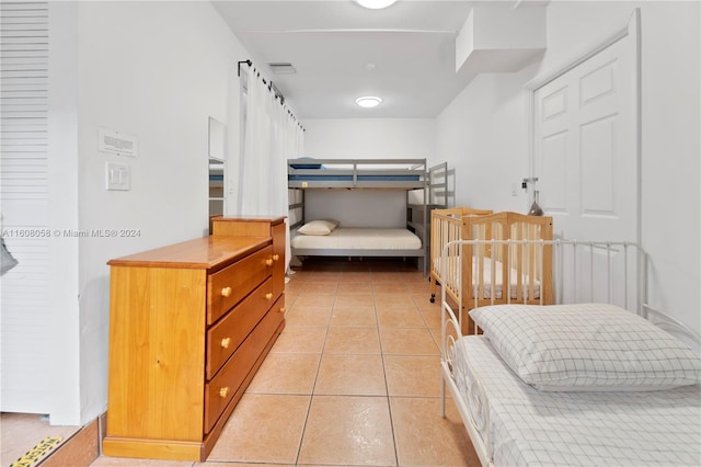 bedroom with light tile patterned floors