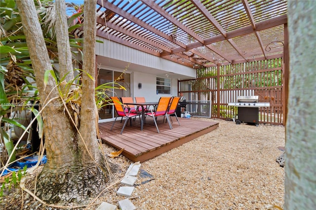 deck with a pergola and a grill