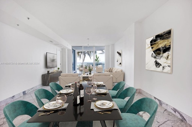 dining space featuring expansive windows