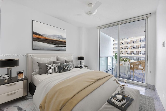 bedroom featuring ceiling fan, marble finish floor, a wall of windows, and access to exterior