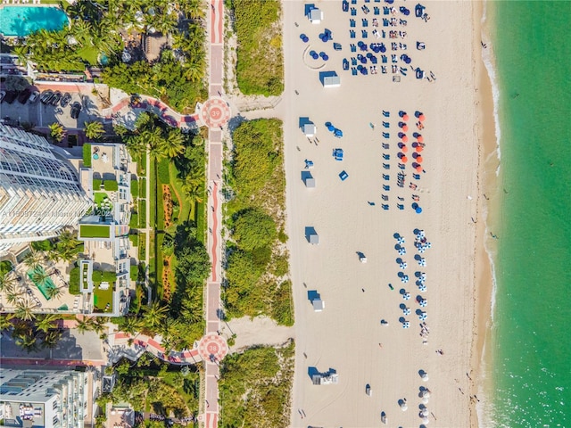 birds eye view of property featuring a water view and a beach view