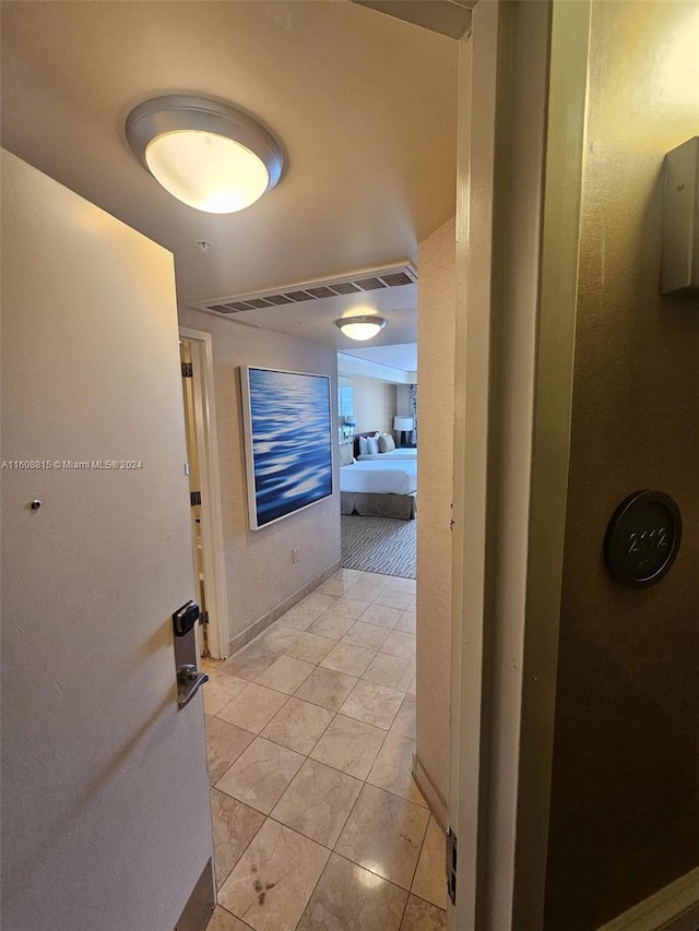 corridor featuring light tile patterned floors