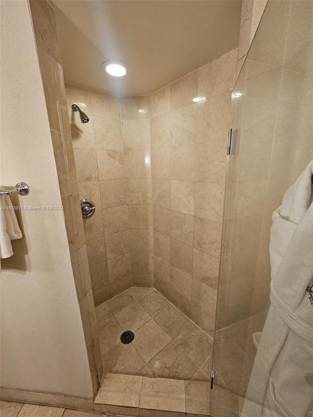 bathroom with a tile shower