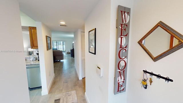 hall with light hardwood / wood-style flooring