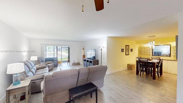 living room featuring light wood-type flooring and ceiling fan