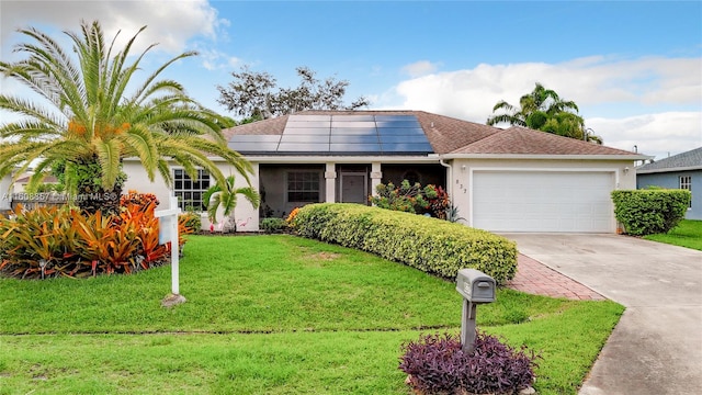 view of front of property with a front yard, a garage, and solar panels