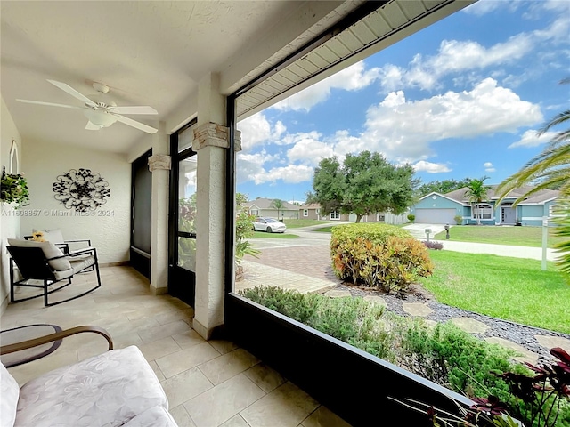 sunroom / solarium featuring ceiling fan