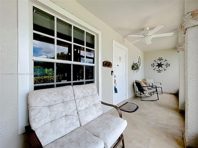 sunroom featuring ceiling fan