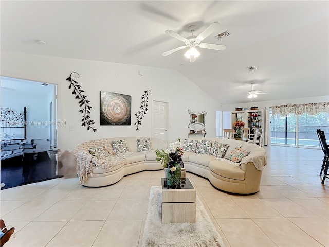 living room with ceiling fan, light tile floors, and lofted ceiling