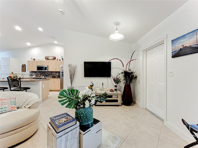 tiled living room featuring vaulted ceiling