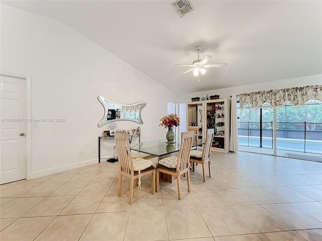 tiled dining room with ceiling fan and vaulted ceiling