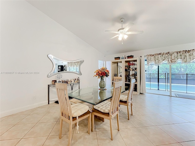 tiled dining area with high vaulted ceiling and ceiling fan