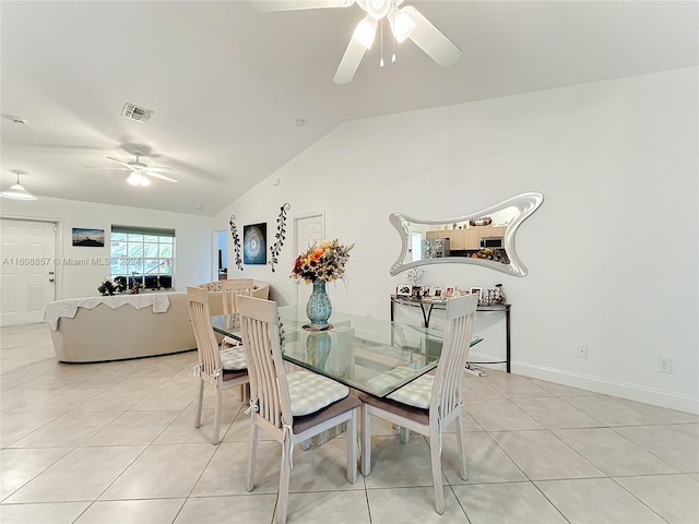 tiled dining room featuring lofted ceiling and ceiling fan