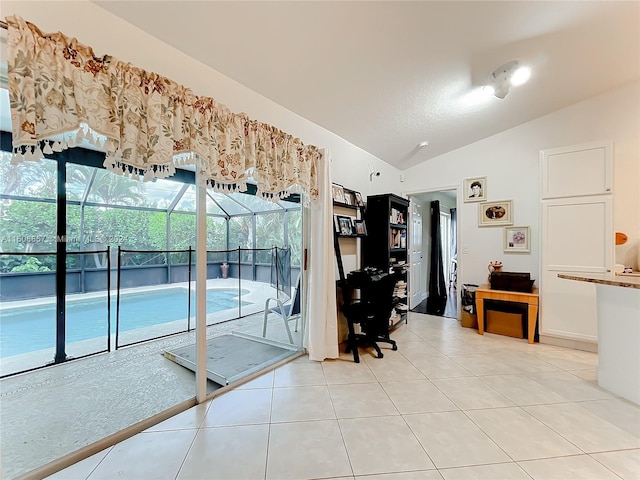 interior space featuring light tile floors and vaulted ceiling