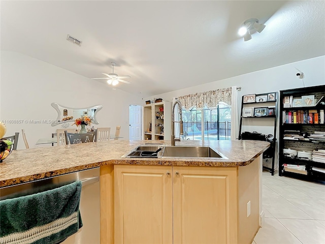 kitchen featuring stainless steel dishwasher, decorative light fixtures, sink, light tile floors, and light brown cabinets