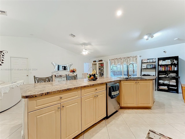 kitchen with ceiling fan, stainless steel dishwasher, sink, light tile floors, and lofted ceiling