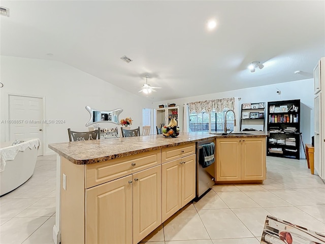 kitchen with sink, dishwashing machine, light tile floors, and lofted ceiling